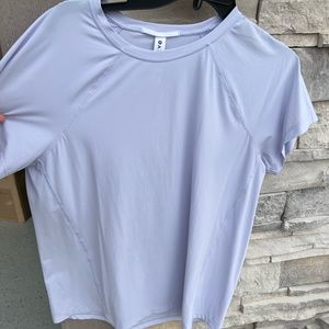 Athleta.  Like new!  Dry fit material but not a fitted top!  Relaxed fit.